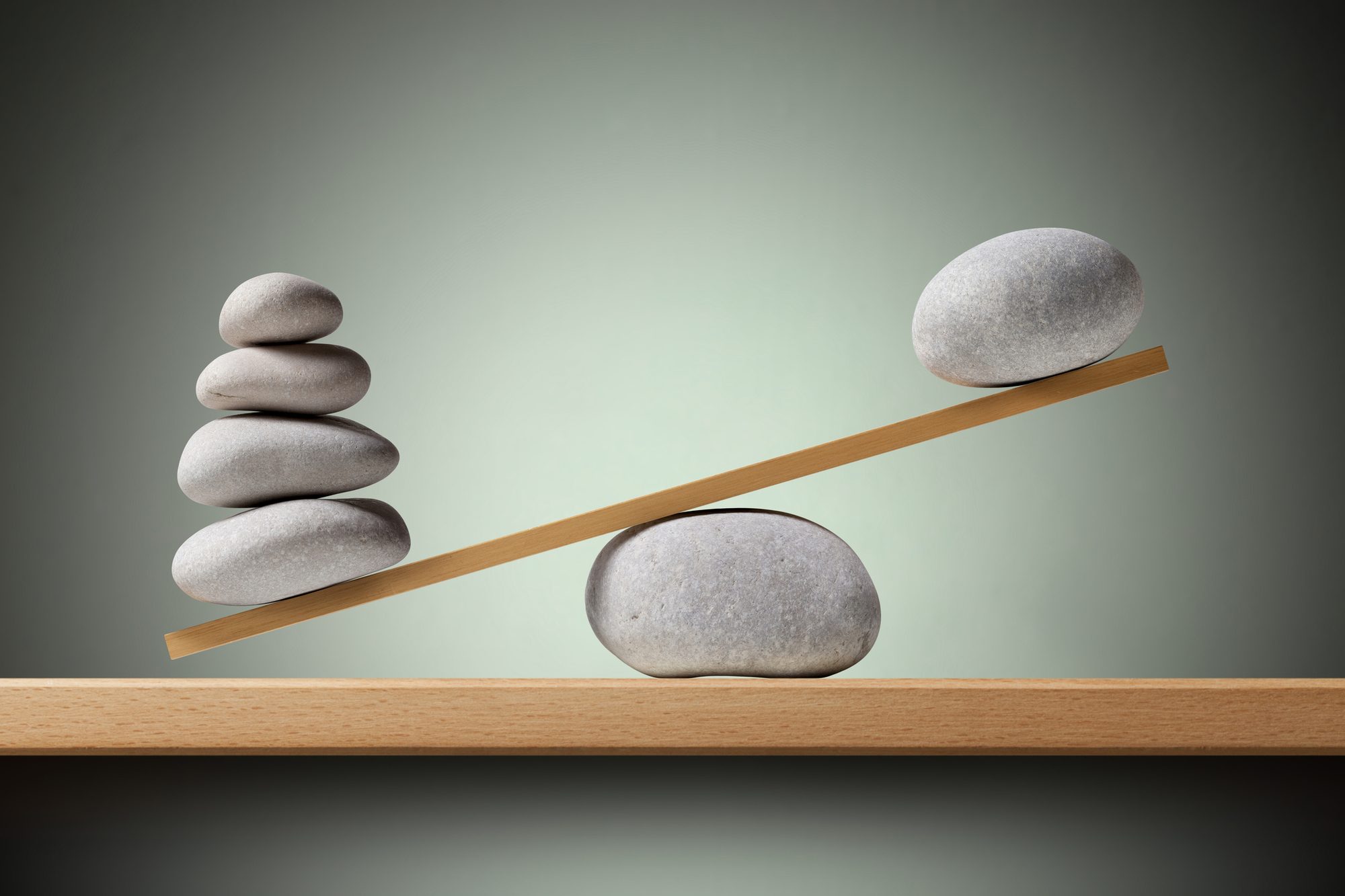 Imbalance. Balancing stones on the shelf